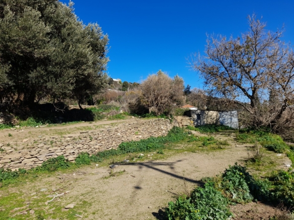 STRAPOURIES. Plot 1102 M2. Frontage on main road with far view to Chora and the sea